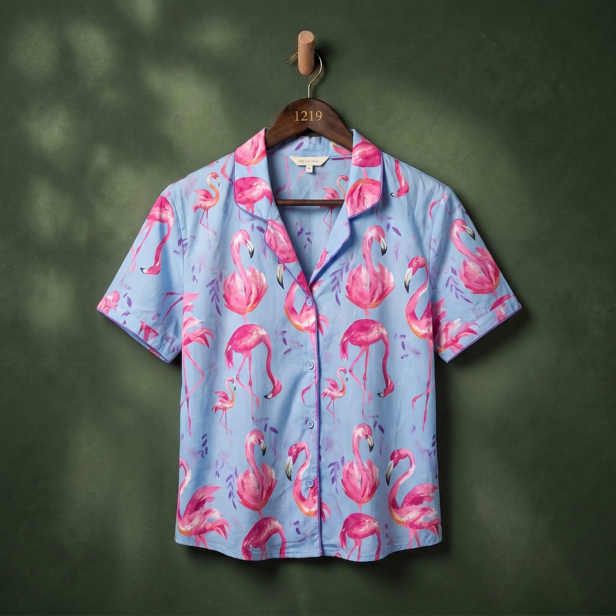 Sky blue flamingo print camp collar women's shirt on hanger