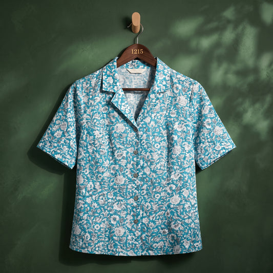 Blue floral print camp collar women's shirt on hanger