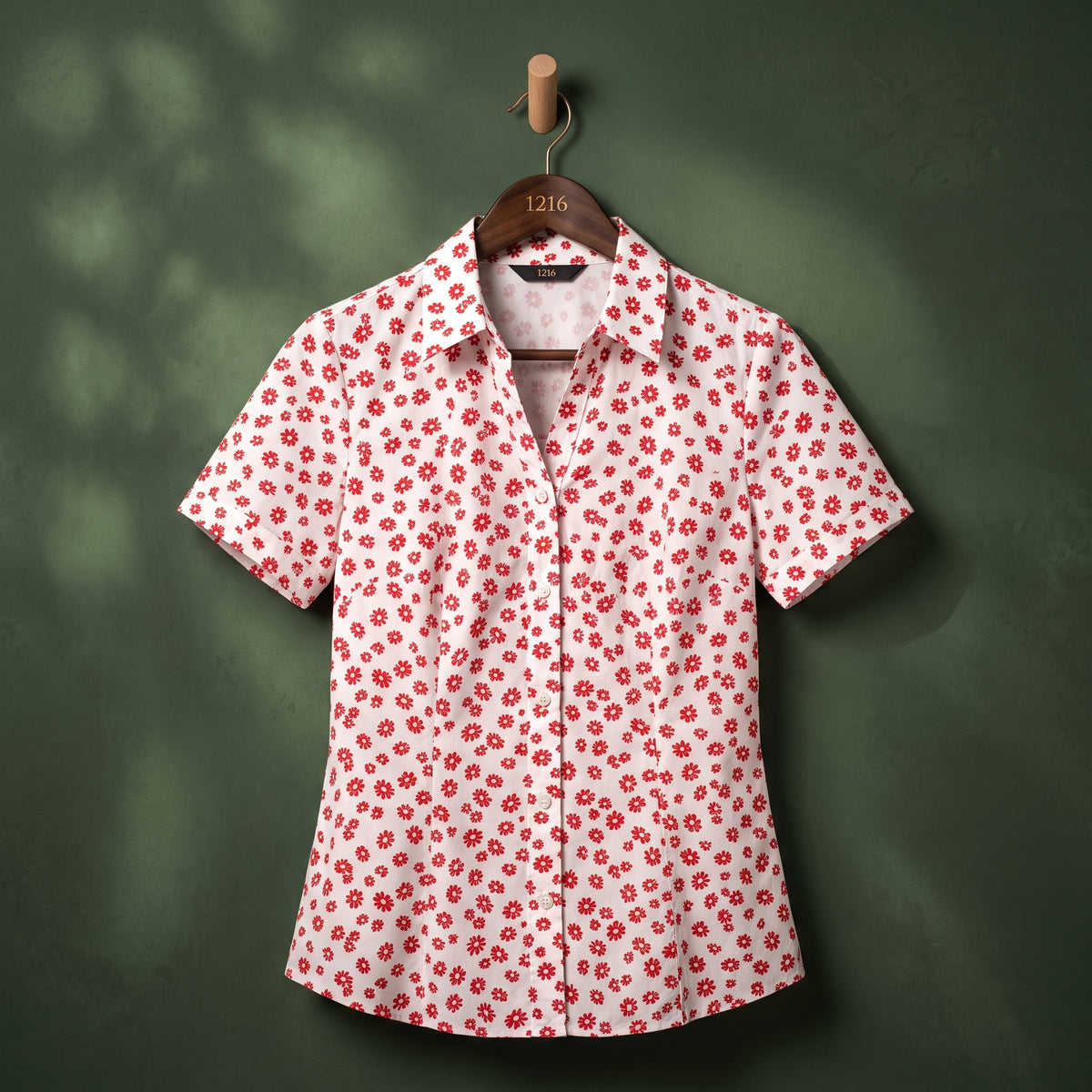White shirt with red daisy print on hanger