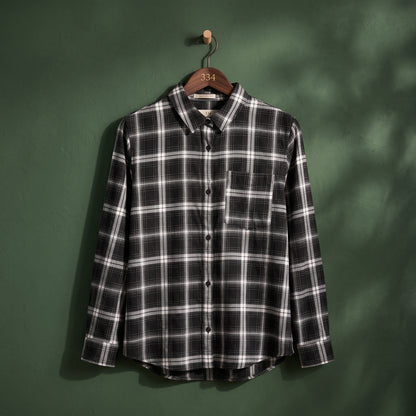 Women's black and white plaid check button-up shirt with long sleeves and chest pocket – front view