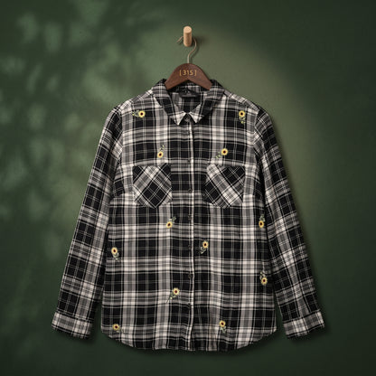 Women's black and white plaid shirt with sunflower embroidery and two chest pockets – front view on hanger