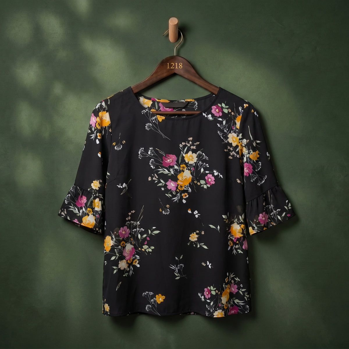 Black floral print flutter sleeve women's top on hanger