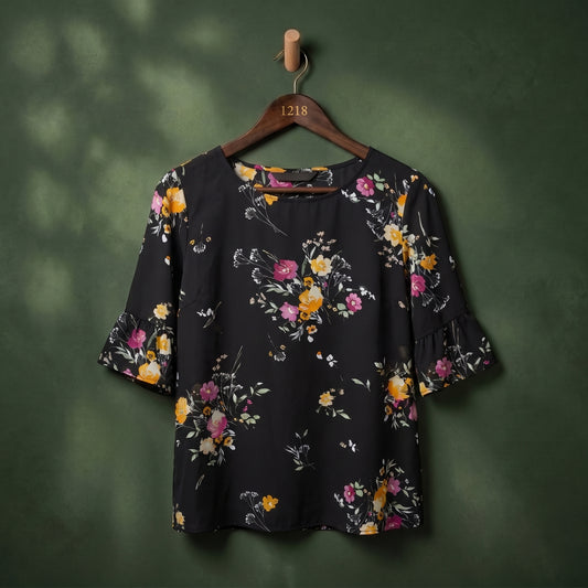 Black floral print flutter sleeve women's top on hanger